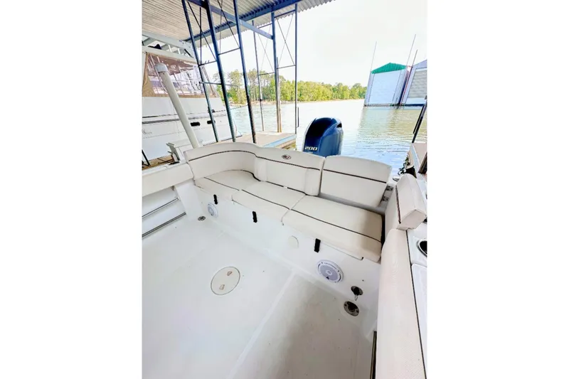 Slide: The Image of 2020 Sea Hunt Ultra 234 boat interior with cushioned seating and Yamaha outboard motor. - 5