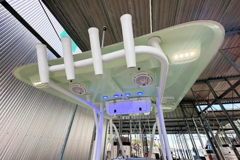 Slide: The Image of 2020 Sea Hunt Ultra 234 boat with rod holders and LED lights under a canopy. - 6