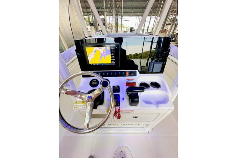 Slide: The Image of 2020 Sea Hunt Ultra 234 boat dashboard with steering wheel and navigation display. - 7