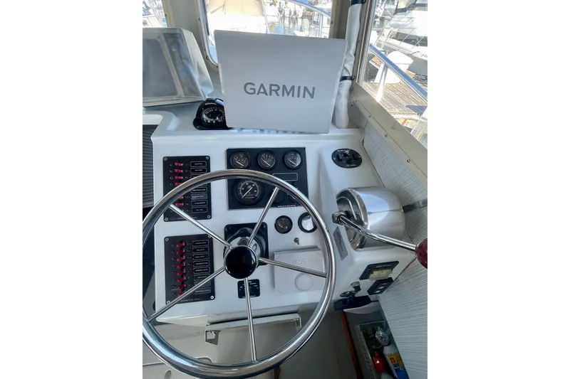 Slide: The Image of Control panel of a 2000 Davis Rock Harbor 25 LC boat with gauges and navigation controls. - 12