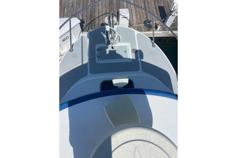 Slide: The Image of Engine compartment of a 2000 Davis Rock Harbor 25 LC boat, showcasing detailed components. - 15