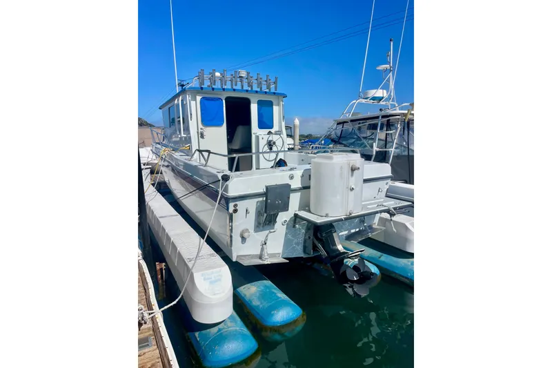 Slide: The Image of Close-up of a 2000 Davis Rock Harbor 25 LC boat with visible motor and logo. - 3