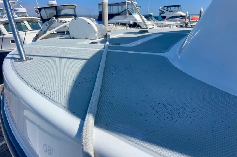 Slide: The Image of Side view of a 2000 Davis Rock Harbor 25 LC boat docked at a marina. - 6