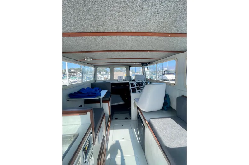 Slide: The Image of 2000 Davis Rock Harbor 25 LC boat docked at marina under clear blue sky. - 9