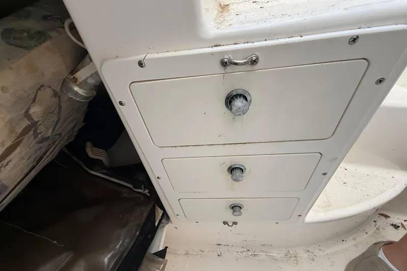 Slide: The Image of Storage compartments on a 2002 Century 2900 Walk-Around boat, featuring three white drawers. - 100