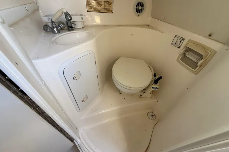 Slide: The Image of 2002 Century 2900 Walk-Around boat bathroom with toilet and sink. - 101