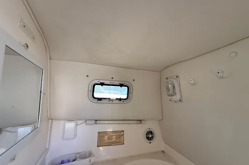 Slide: The Image of Interior cabin of 2002 Century 2900 Walk-Around boat with window and storage. - 103