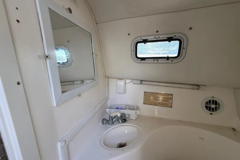 Slide: The Image of Interior of 2002 Century 2900 Walk-Around boat bathroom with sink and mirror. - 104