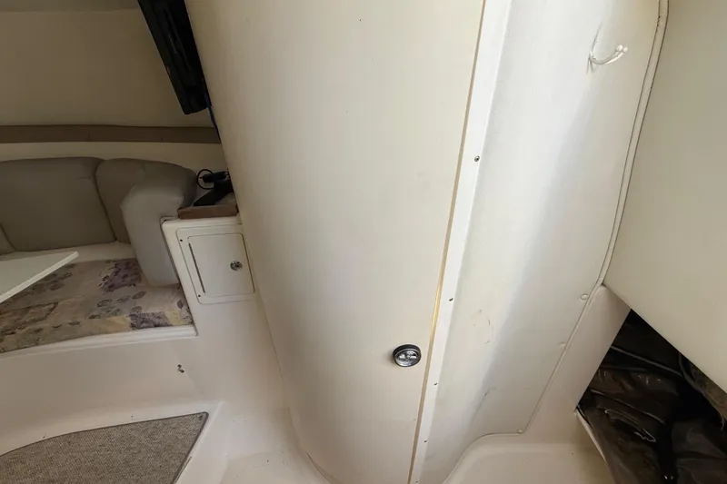 Slide: The Image of Interior cabin of a 2002 Century 2900 Walk-Around boat, featuring seating and storage. - 105