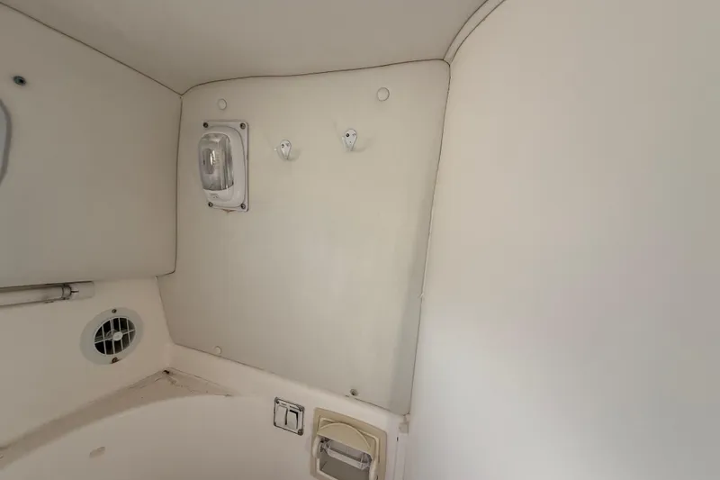 Slide: The Image of Interior of 2002 Century 2900 Walk-Around boat, featuring light fixture and ventilation. - 106