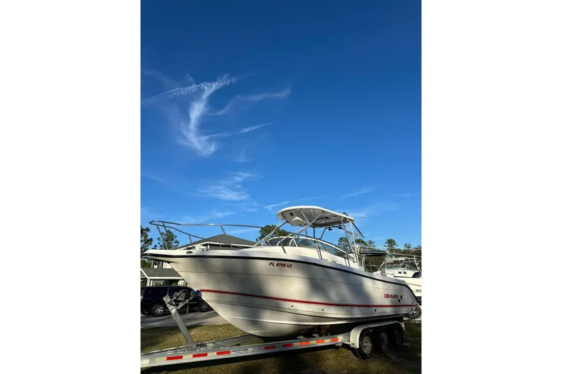 Slide: The Image of 2002 Century 2900 Walk-Around boat on trailer under clear blue sky. - 11