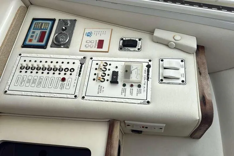 Slide: The Image of Control panel of a 2002 Century 2900 Walk-Around boat with switches and gauges. - 13