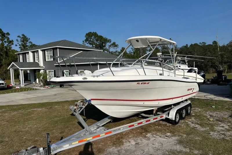 Slide: The Image of 2002 Century 2900 Walk-Around boat on trailer, parked in front of a house. - 16