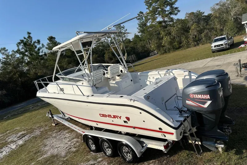 Slide: The Image of 2002 Century 2900 Walk-Around boat with dual Yamaha engines on a trailer. - 17
