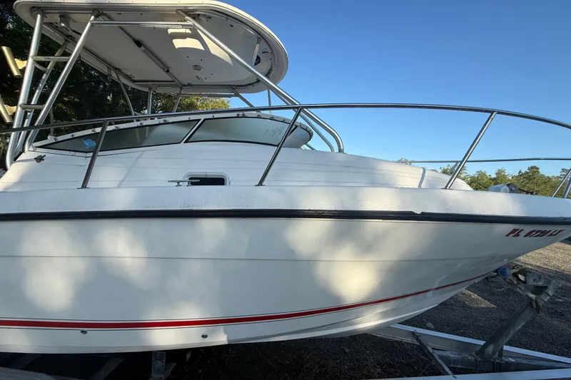 Slide: The Image of 2002 Century 2900 Walk-Around boat on trailer, side view under clear blue sky. - 21
