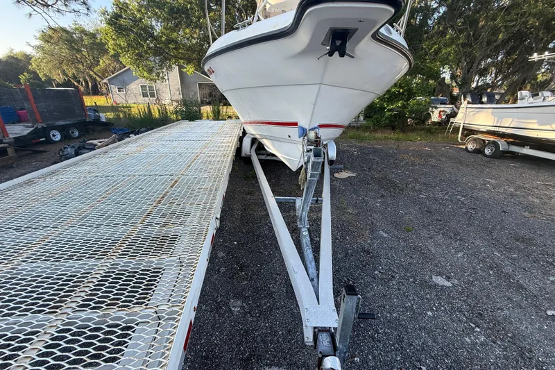 Slide: The Image of 2002 Century 2900 Walk-Around boat on trailer in outdoor setting. - 25