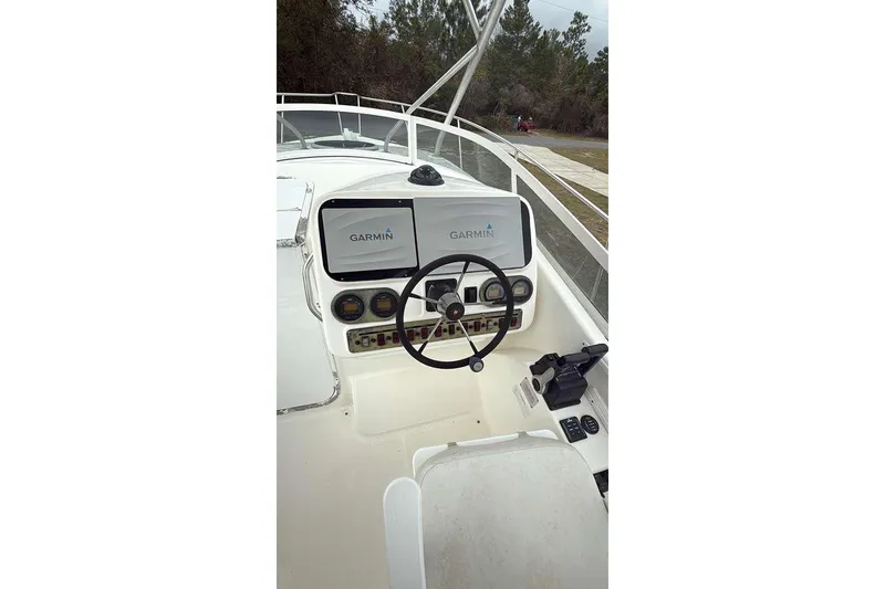 Slide: The Image of 2002 Century 2900 Walk-Around boat helm with Garmin navigation system and steering wheel. - 3