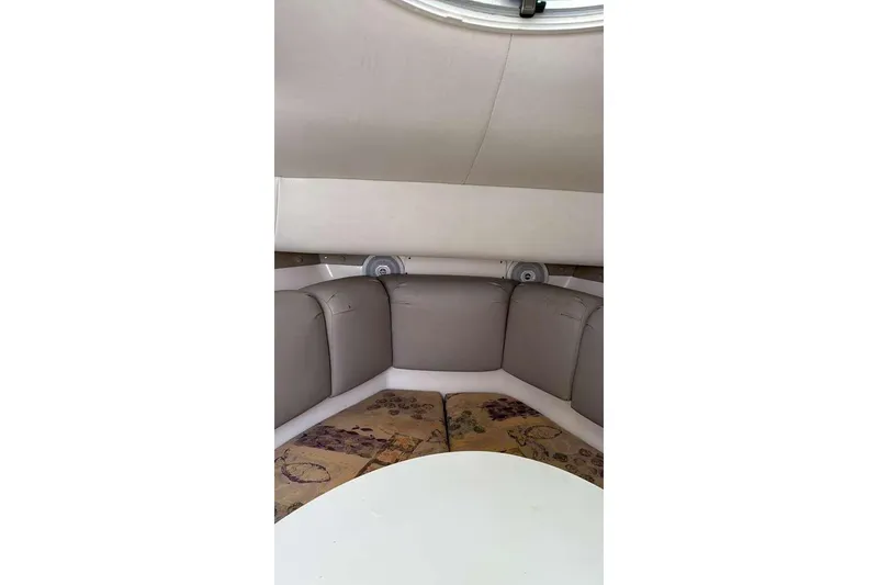 Slide: The Image of Interior of 2002 Century 2900 Walk-Around boat with cushioned seating and speakers. - 4