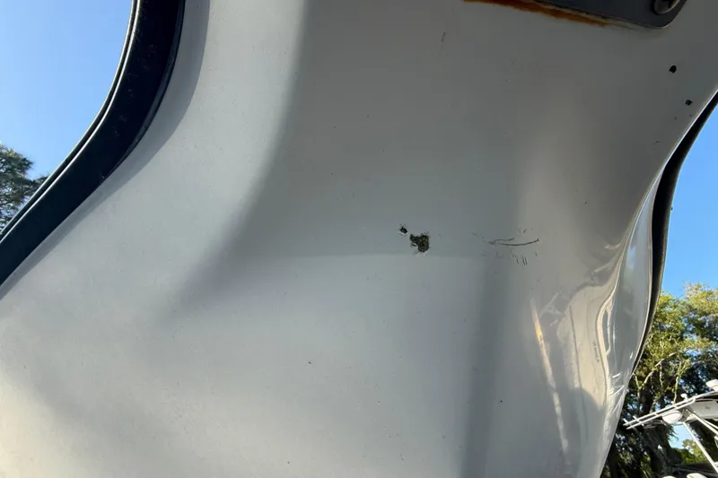Slide: The Image of Close-up of a 2002 Century 2900 Walk-Around boat hull with minor scratches. - 44