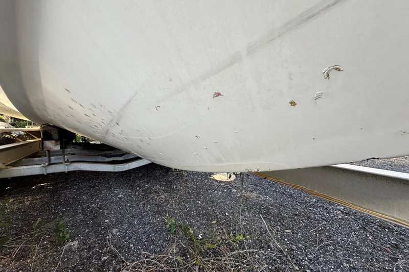 Slide: The Image of 2002 Century 2900 Walk-Around boat hull with visible scratches on trailer. - 45