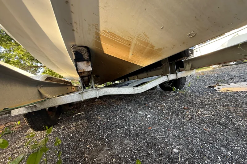 Slide: The Image of Underneath view of a 2002 Century 2900 Walk-Around boat on a trailer. - 46