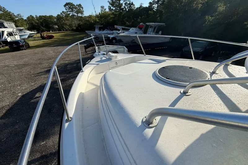 Slide: The Image of 2002 Century 2900 Walk-Around boat on display in a sunny outdoor setting. - 49