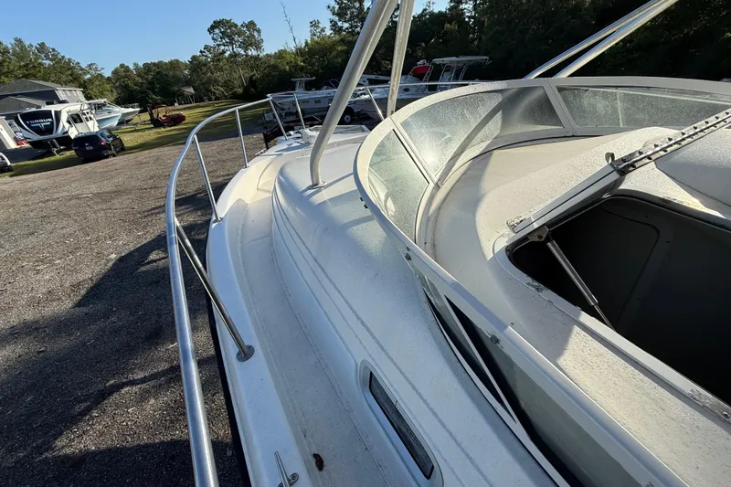 Slide: The Image of 2002 Century 2900 Walk-Around boat on display in a sunny outdoor setting. - 50