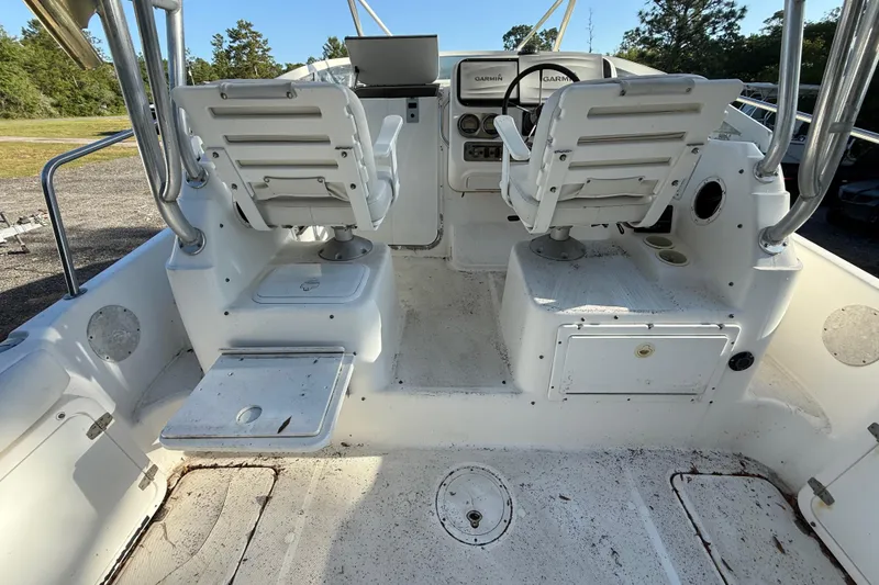 Slide: The Image of 2002 Century 2900 Walk-Around boat interior with dual captain chairs and control panel. - 53