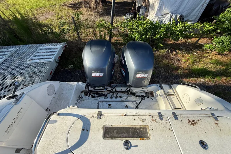 Slide: The Image of 2002 Century 2900 Walk-Around boat with twin Yamaha 225 engines, parked outdoors. - 54