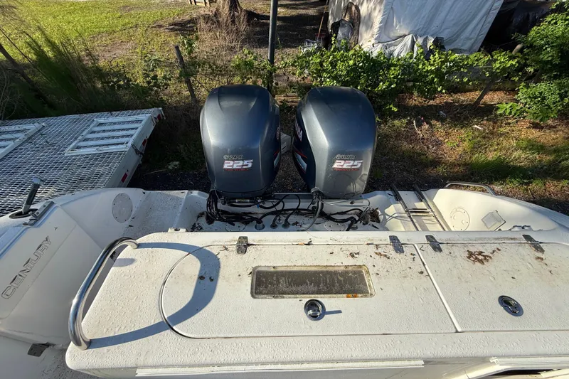 Slide: The Image of 2002 Century 2900 Walk-Around boat with twin Yamaha 225 engines, parked outdoors. - 55
