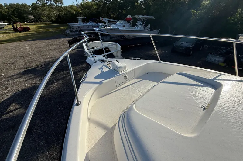 Slide: The Image of 2002 Century 2900 Walk-Around boat deck with railing, parked outdoors. - 56