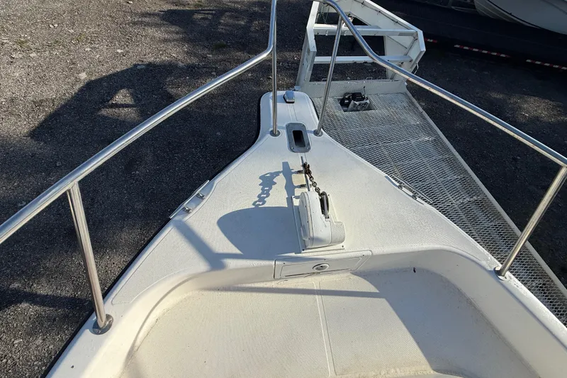 Slide: The Image of 2002 Century 2900 Walk-Around boat deck with anchor and railing. - 57