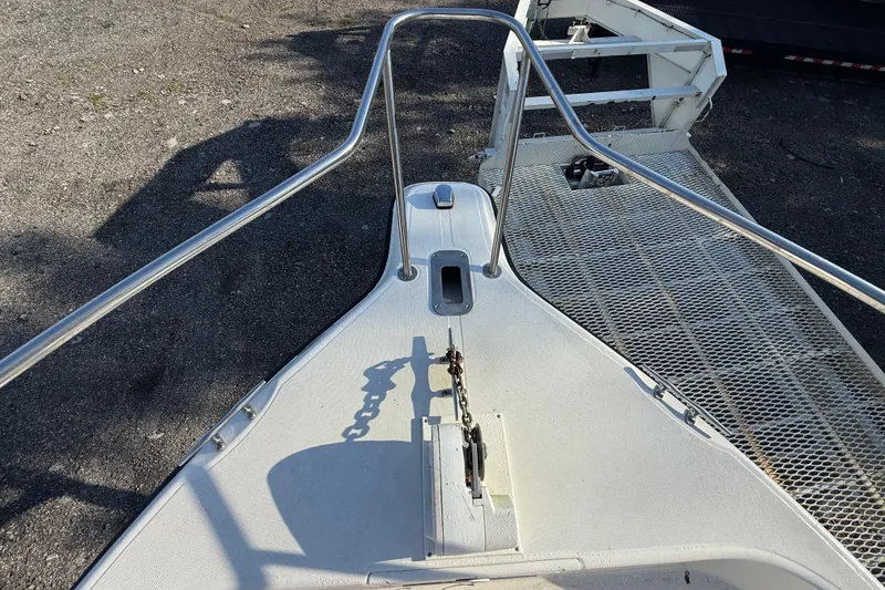 Slide: The Image of Bow view of 2002 Century 2900 Walk-Around boat with anchor chain and railing. - 58