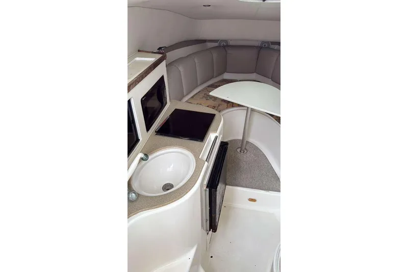 Slide: The Image of 2002 Century 2900 Walk-Around cabin interior with kitchenette and seating area. - 6