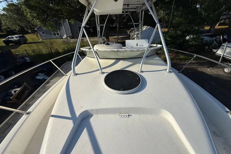 Slide: The Image of 2002 Century 2900 Walk-Around boat deck with railing and hatch, parked outdoors. - 60