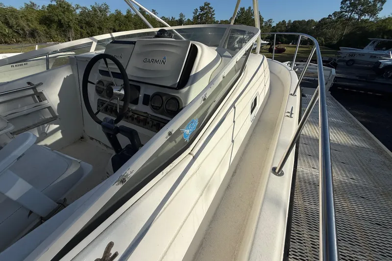 Slide: The Image of 2002 Century 2900 Walk-Around boat with Garmin navigation system, docked outdoors. - 64