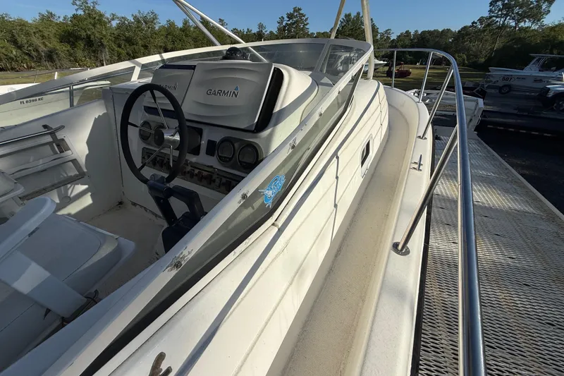 Slide: The Image of 2002 Century 2900 Walk-Around boat with Garmin navigation system, docked outdoors. - 65