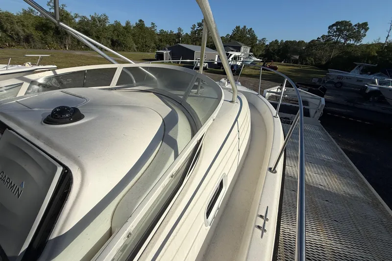 Slide: The Image of 2002 Century 2900 Walk-Around boat on trailer, surrounded by trees and other boats. - 66