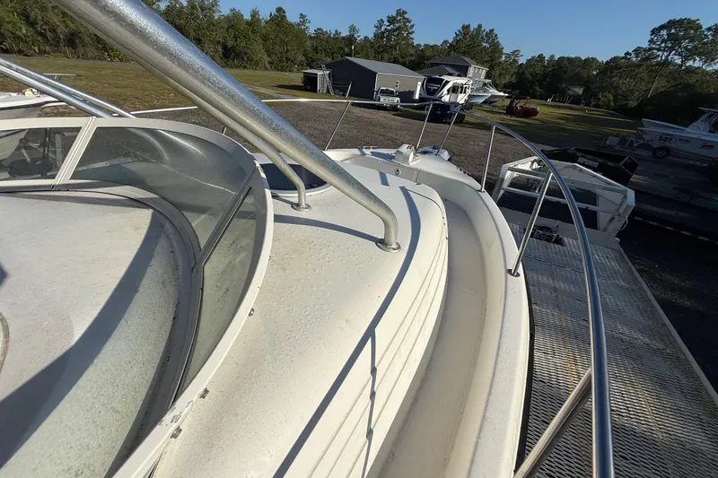Slide: The Image of 2002 Century 2900 Walk-Around boat on trailer, surrounded by trees and other boats. - 67