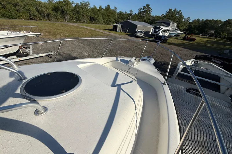 Slide: The Image of 2002 Century 2900 Walk-Around boat deck with railing, parked outdoors. - 68
