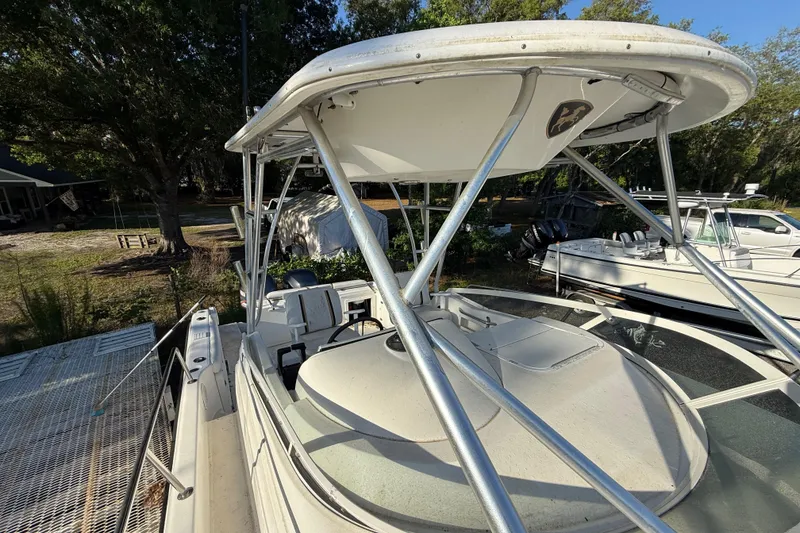 Slide: The Image of 2002 Century 2900 Walk-Around boat with canopy, docked outdoors. - 70