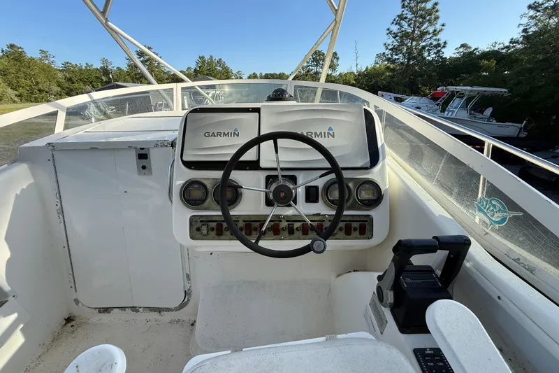 Slide: The Image of Century 2900 Walk-Around 2002 boat cockpit with Garmin navigation system and steering wheel. - 72