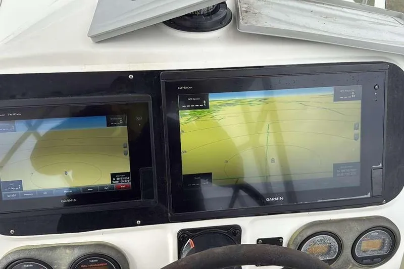 Slide: The Image of Garmin navigation screens on a 2002 Century 2900 Walk-Around boat dashboard. - 76