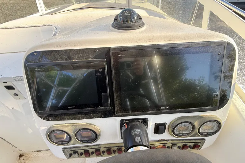 Slide: The Image of Century 2900 Walk-Around 2002 boat dashboard with Garmin displays and compass. - 80