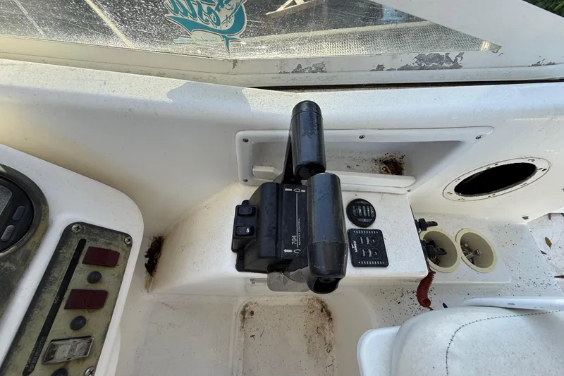 Slide: The Image of Control panel of a 2002 Century 2900 Walk-Around boat, featuring throttle and switches. - 81