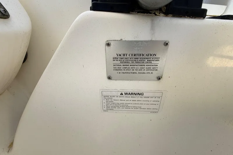 Slide: The Image of Yacht certification and warning labels on a 2002 Century 2900 Walk-Around boat. - 82