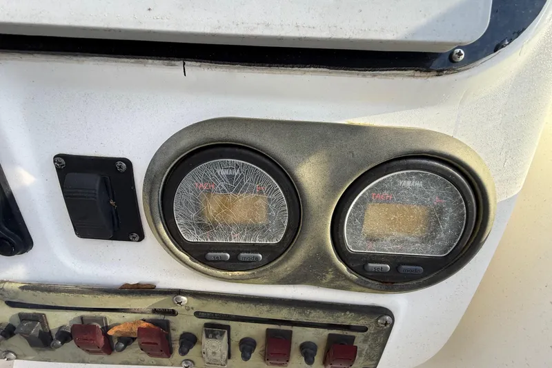 Slide: The Image of Dashboard of a 2002 Century 2900 Walk-Around boat with cracked gauges. - 83