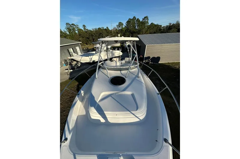 Slide: The Image of 2002 Century 2900 Walk-Around boat docked outdoors, showcasing spacious deck and sleek design. - 9
