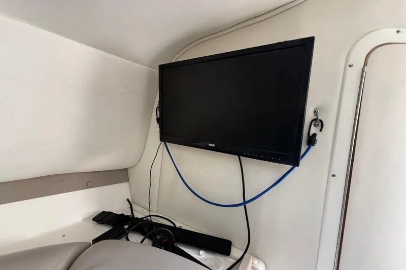 Slide: The Image of Flat-screen TV setup inside a 2002 Century 2900 Walk-Around boat cabin. - 90