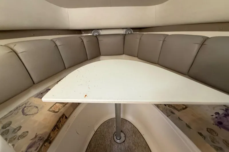 Slide: The Image of Interior of 2002 Century 2900 Walk-Around boat with cushioned seating and table. - 92